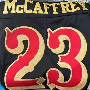 Black and Gold Sports Jersey with Red Accents